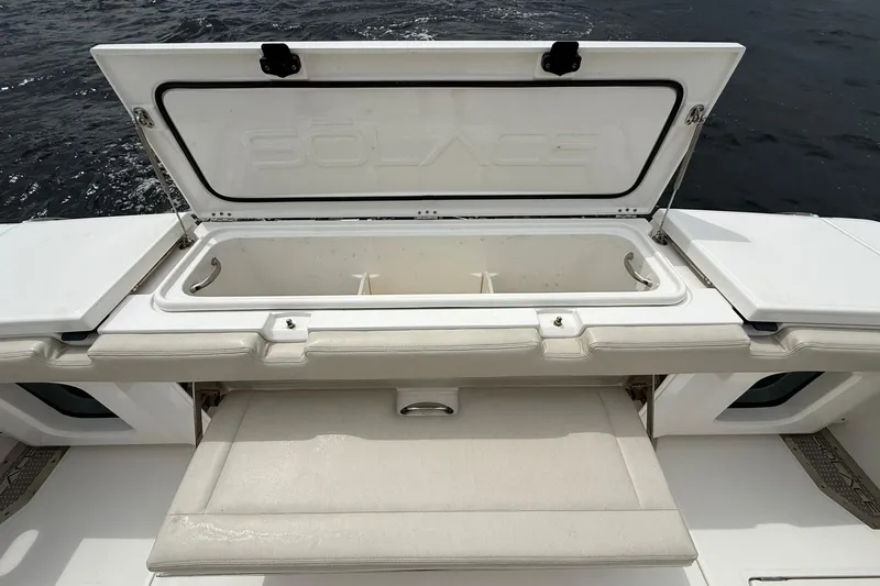 Slide: The Image of Open storage compartment on 2022 Solace 41CS boat, featuring sleek white design. - 42