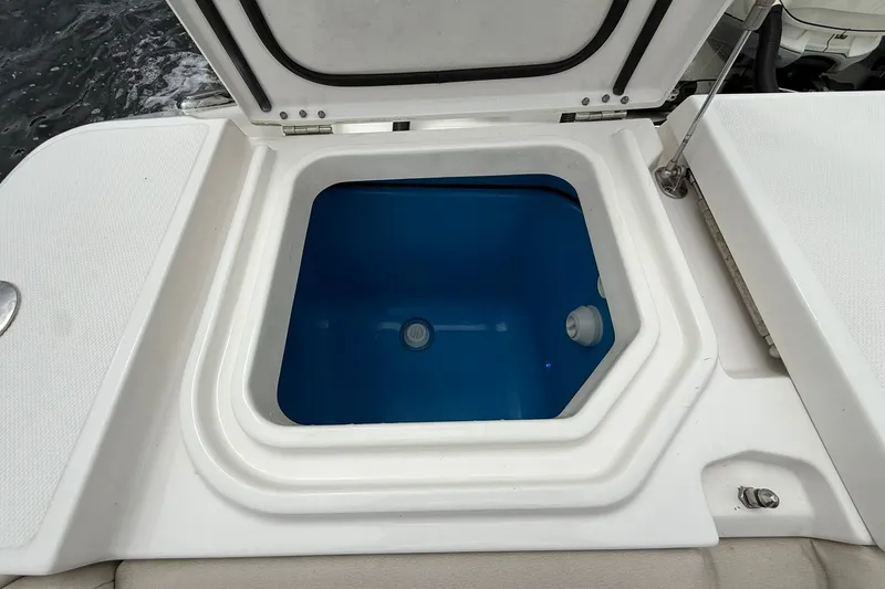 Slide: The Image of Open storage compartment on 2022 Solace 41CS boat, featuring a blue interior. - 44