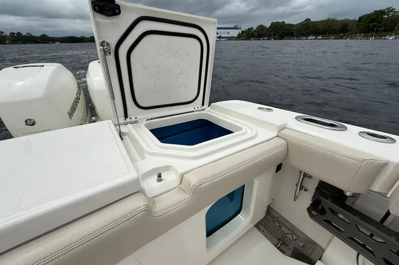 Slide: The Image of Open storage compartment on 2022 Solace 41CS boat, near water with Mercury engines. - 46