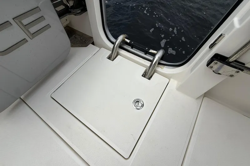 Slide: The Image of 2022 Solace 41CS boat deck with hatch and stainless steel ladder by the water. - 50