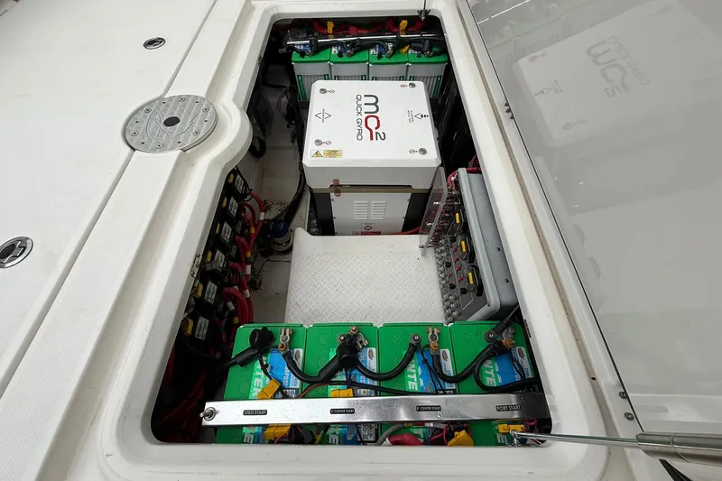 Slide: The Image of Battery compartment of 2022 Solace 41CS boat, featuring multiple batteries and electrical components. - 54