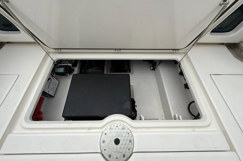 Slide: The Image of Open storage compartment of 2022 Solace 41CS boat, showcasing interior equipment and components. - 56