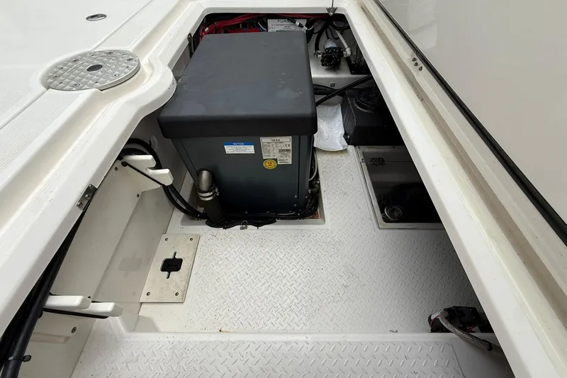Slide: The Image of Interior view of a 2022 Solace 41CS boat compartment with equipment and wiring. - 57