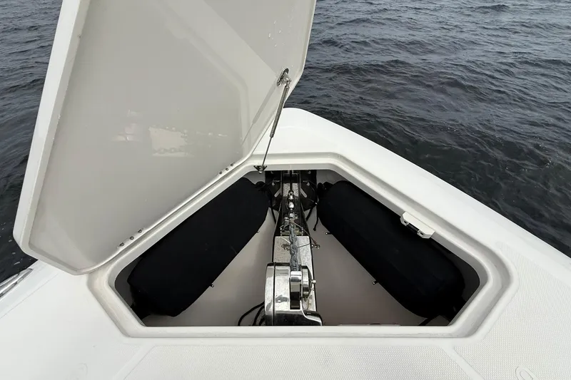 Slide: The Image of Open anchor hatch on 2022 Solace 41CS boat, showing anchor mechanism and storage. - 6