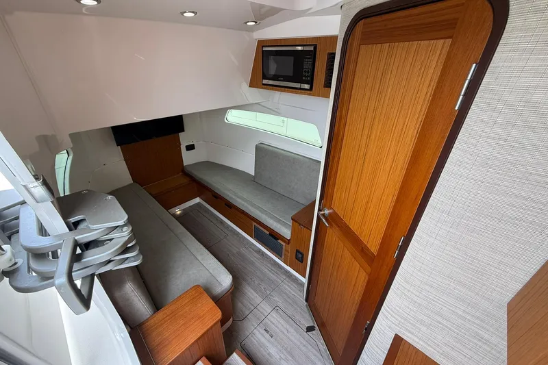 Slide: The Image of 2022 Solace 41CS cabin interior with wooden accents and modern seating. - 60
