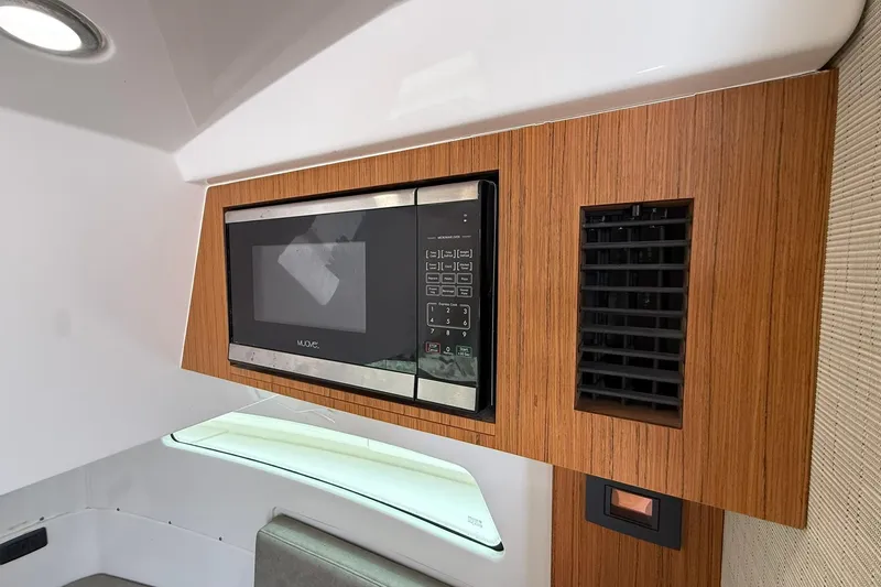Slide: The Image of 2022 Solace 41CS interior with built-in microwave and wooden cabinetry. - 63