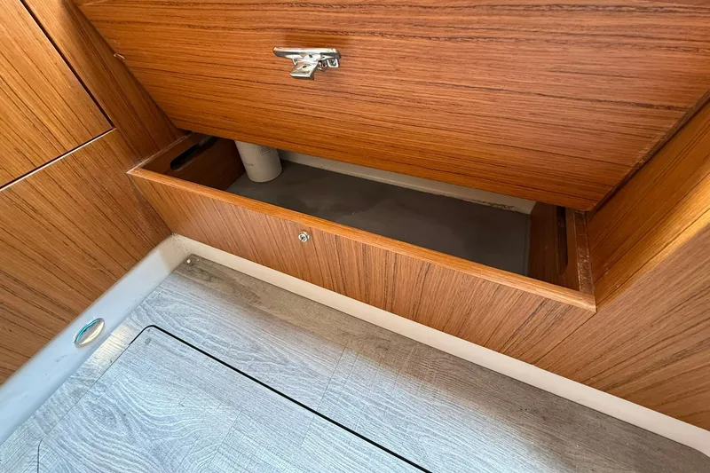 Slide: The Image of Open wooden storage compartment in 2022 Solace 41CS boat interior. - 68