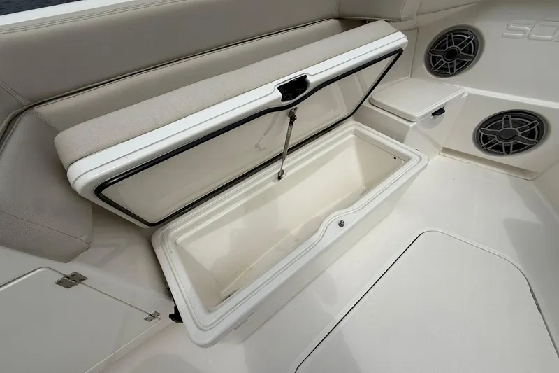 Slide: The Image of 2022 Solace 41CS boat storage compartment with open lid and speakers. - 8