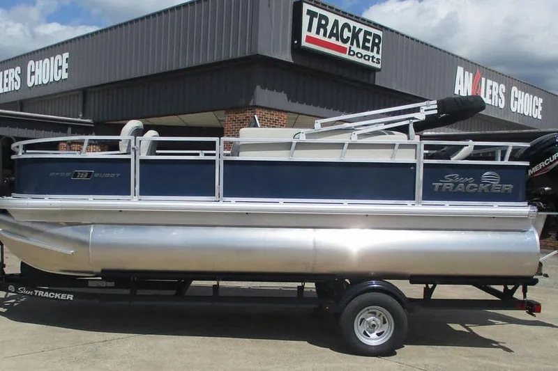 The Image of 2026 Sun Tracker Bass Buggy 18 DLX pontoon boat displayed at dealership. - 1