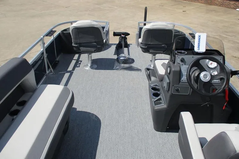 Slide: The Image of 2026 Sun Tracker Bass Buggy 18 DLX pontoon boat interior with seating and steering console. - 3