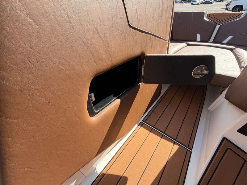 Slide: The Image of Brown upholstery and wood flooring with an open storage compartment on a boat. - 16