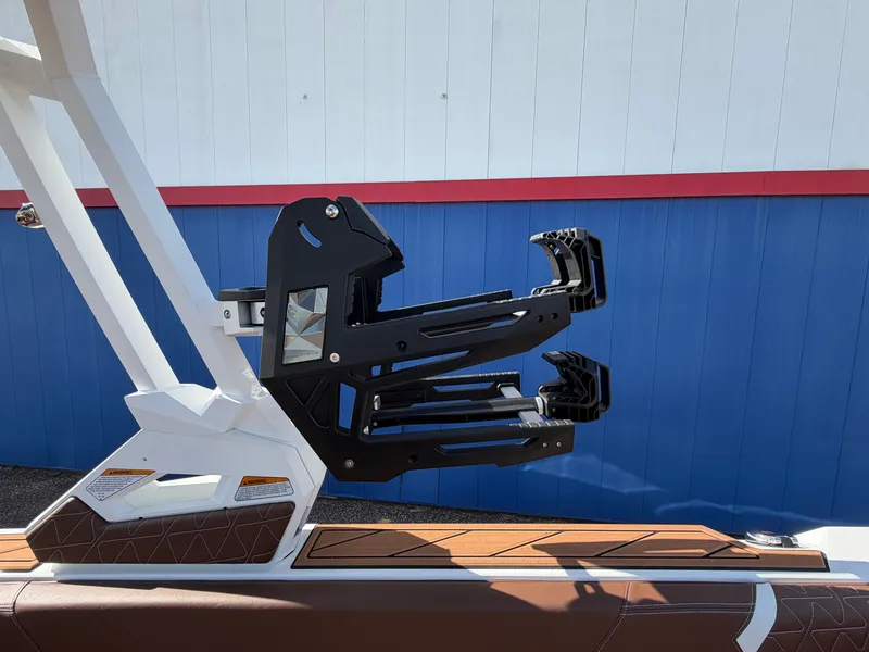 Slide: The Image of A modern boat with a black wakeboard rack on the side. - 43