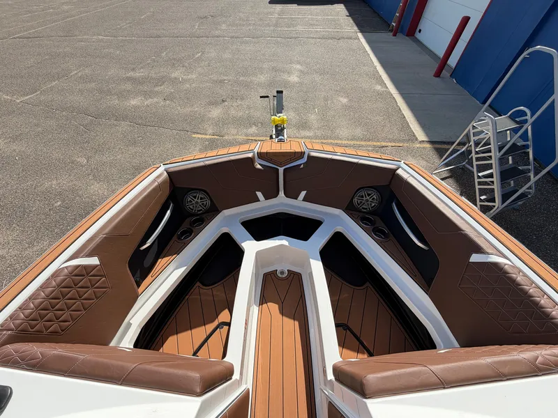 Slide: The Image of The image shows the bow of a 2027 Nautique GS22SUPER AIR with brown upholstery. - 13
