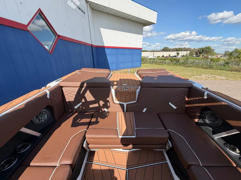 Slide: The Image of The image shows the luxurious cockpit of a 2027 Nautique GS22 Super Air with brown leather seating. - 46