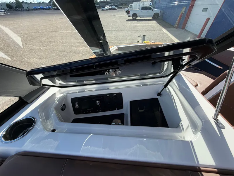 Slide: The Image of The image shows the interior of a 2027 Nautique GS22 Super Air with an open storage compartment. - 27