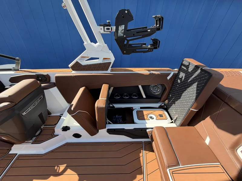 Slide: The Image of The image shows the interior of a 2027 Nautique GS22 Super Air with brown seating and modern features. - 41