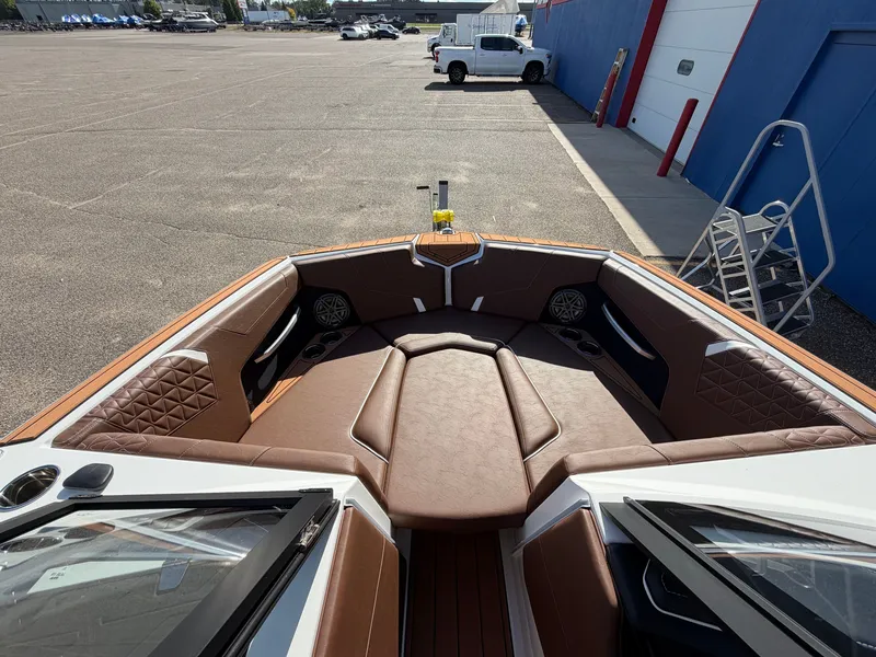 Slide: The Image of The image shows the bow of a 2027 Nautique GS22 Super Air with brown upholstery. - 15