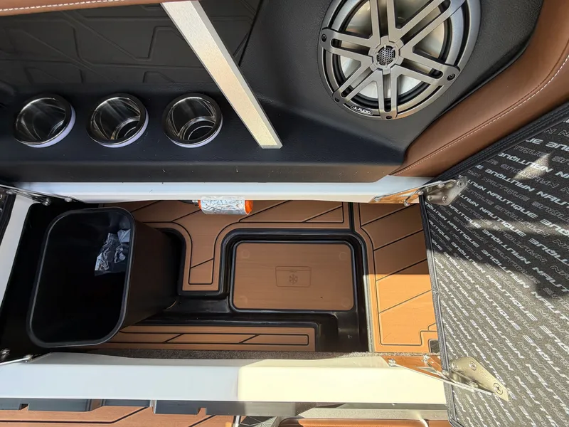 Slide: The Image of Interior of a Nautique GS22 Super Air with speaker, cup holders, and storage space. - 39