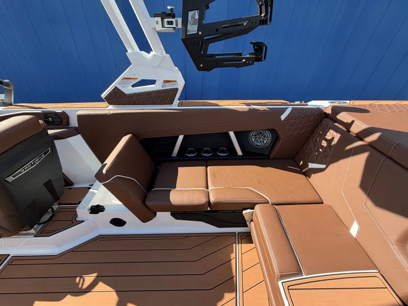 Slide: The Image of The image shows the interior of a 2027 Nautique GS22 Super Air with brown leather seating. - 36