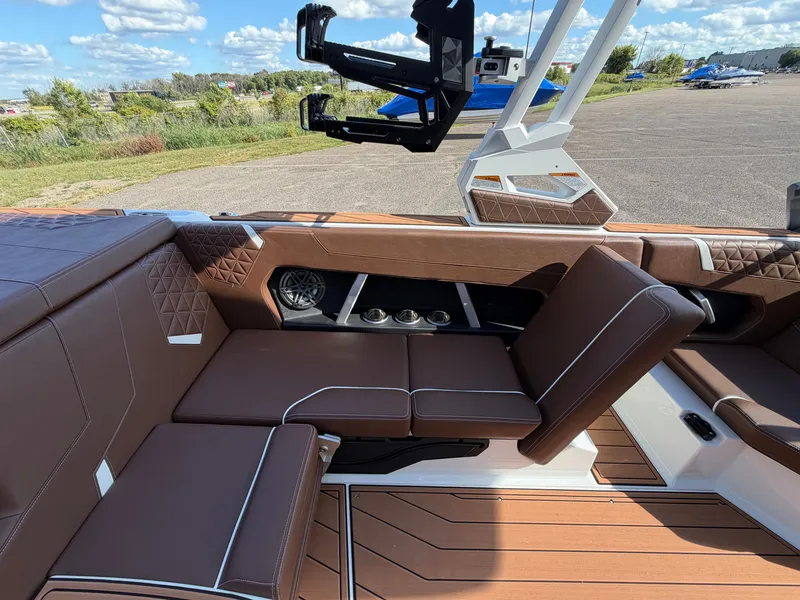 Slide: The Image of The image shows the luxurious interior of a Nautique GS22 Super Air with brown seating and modern details. - 32