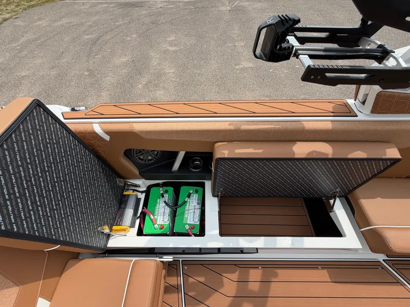 Slide: The Image of The image shows the storage area of a 2027 Nautique Super Air Nautique GS24 with batteries. - 28
