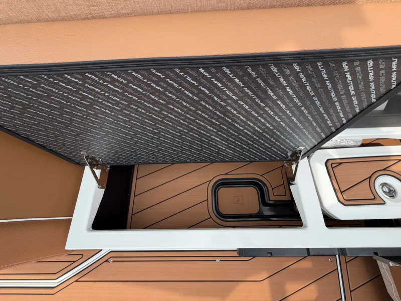 Slide: The Image of Close-up of a storage compartment on a 2027 Nautique Super Air Nautique GS24 boat. - 25