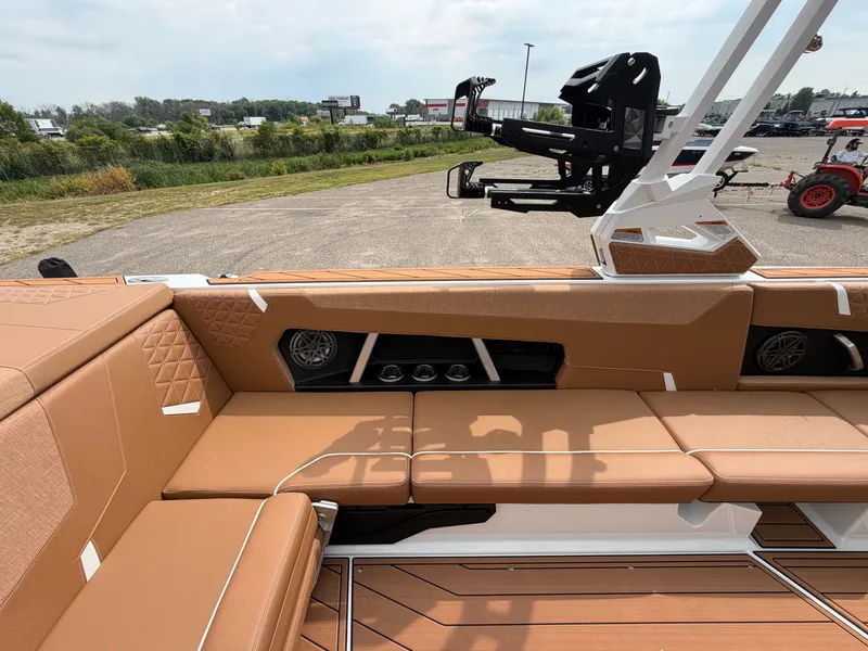 Slide: The Image of The image shows the interior of a 2027 Nautique Super Air Nautique GS24 with brown upholstery. - 26