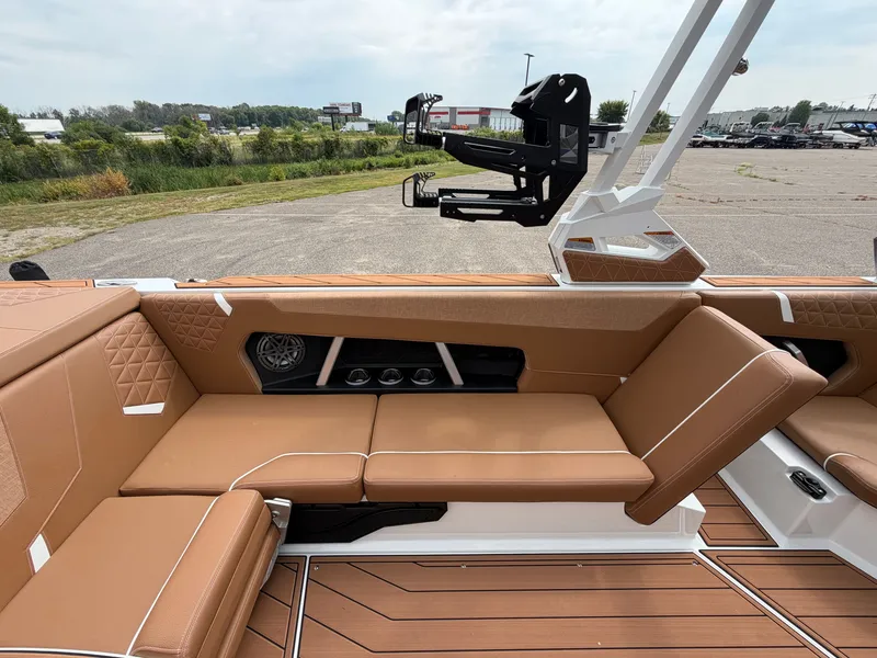 Slide: The Image of The image shows the interior of a 2027 Nautique Super Air Nautique GS24 with brown leather seating. - 27