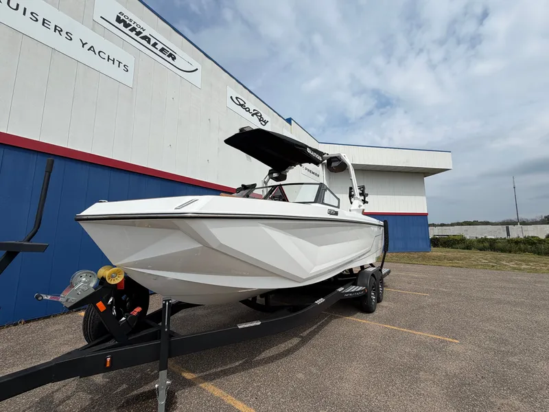 Slide: The Image of A white boat on a trailer in front of a building. It features a black canopy. - 3