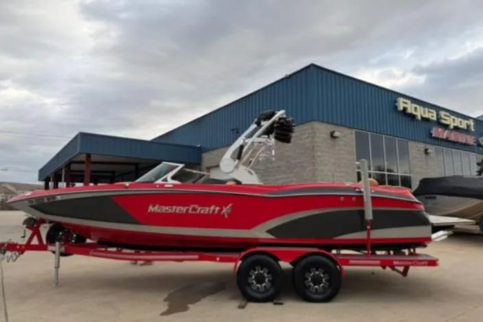 The Image of 2017 MasterCraft X-46 boat in red and gray, parked outside Aqua Sport building. - 0