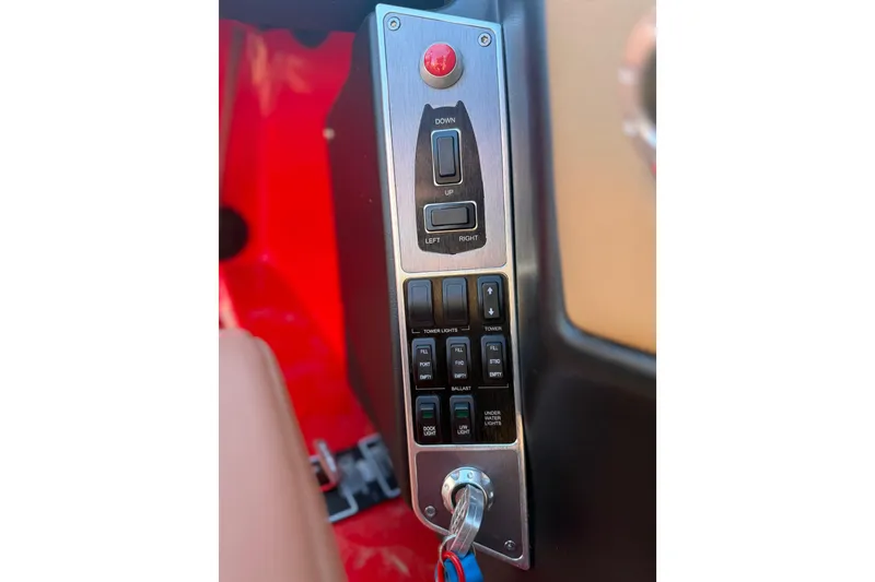 Slide: The Image of Control panel of a 2017 MasterCraft X-46 boat with switches and key ignition. - 12