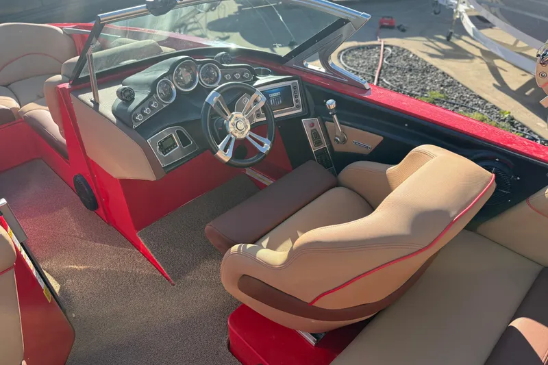 Slide: The Image of Interior of a 2017 MasterCraft X-46 boat with red and beige seating. - 13