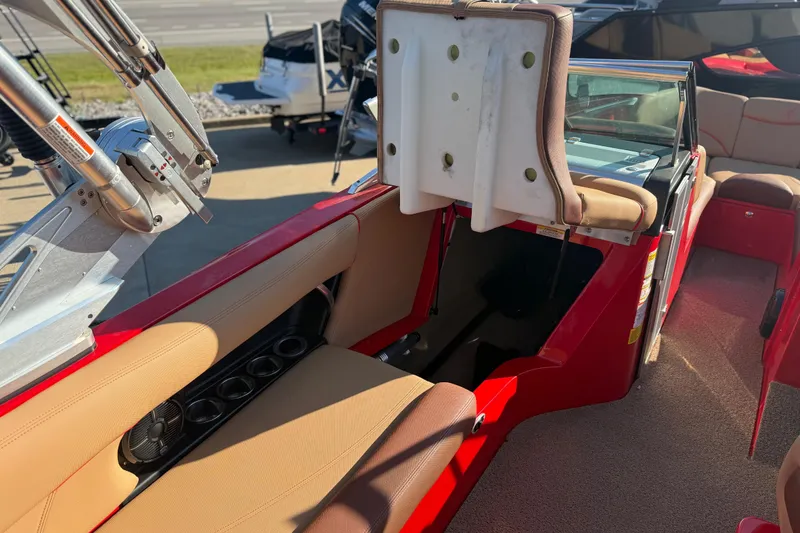 Slide: The Image of 2017 MasterCraft X-46 boat interior with red and beige seating, open storage compartment. - 16