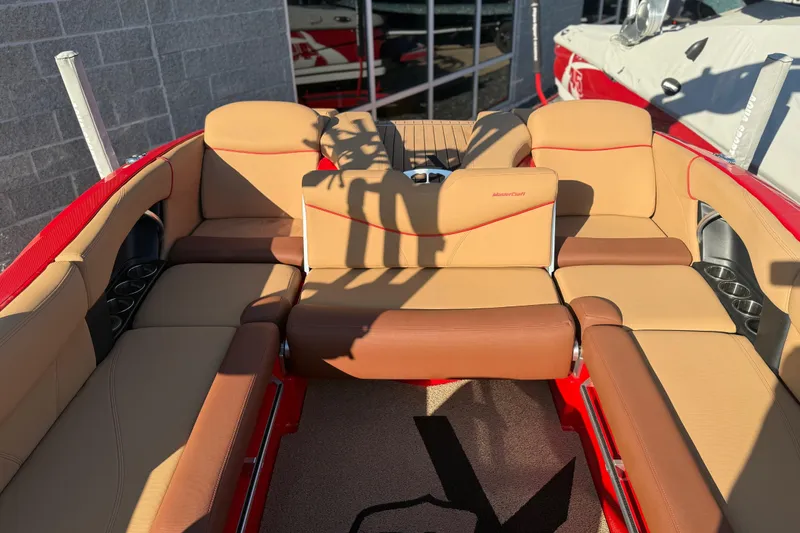 Slide: The Image of 2017 MasterCraft X-46 boat interior with tan and brown seating, red accents. - 18