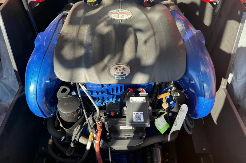 Slide: The Image of 2017 MasterCraft X-46 engine compartment with Ilmor marine engine, showcasing blue components. - 19
