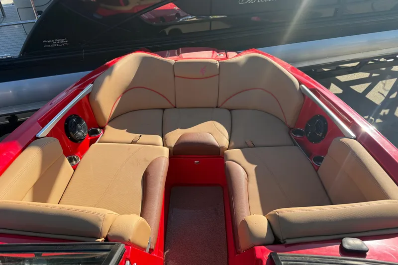 Slide: The Image of 2017 MasterCraft X-46 boat interior with tan seating and red accents. - 2