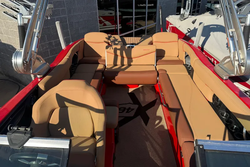 Slide: The Image of 2017 MasterCraft X-46 boat interior with tan seating and red accents. - 4