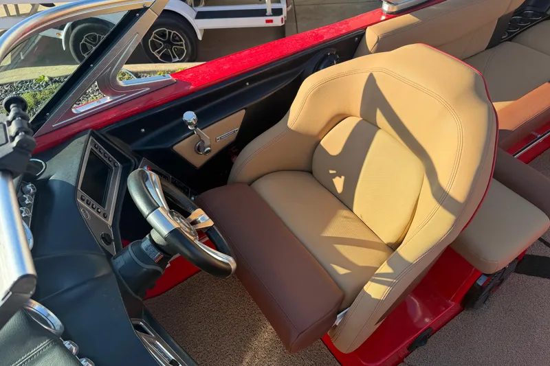 Slide: The Image of 2017 MasterCraft X-46 boat interior with tan seating and modern dashboard. - 6