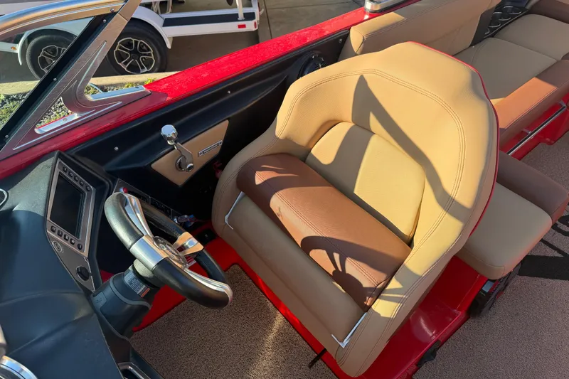 Slide: The Image of 2017 MasterCraft X-46 boat interior with tan seats and sleek steering wheel design. - 7