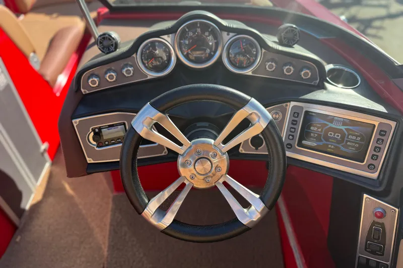 Slide: The Image of Steering wheel and dashboard of 2017 MasterCraft X-46 boat, featuring gauges and controls. - 8