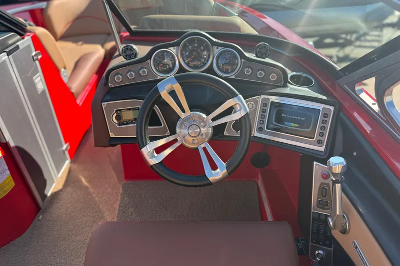 Slide: The Image of 2017 MasterCraft X-46 boat dashboard with steering wheel and control panel. - 9