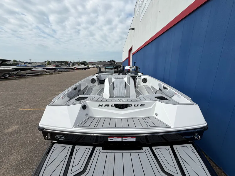 Slide: The Image of A modern 2027 Ski Nautique is parked. The boat features a sleek, white design. - 5