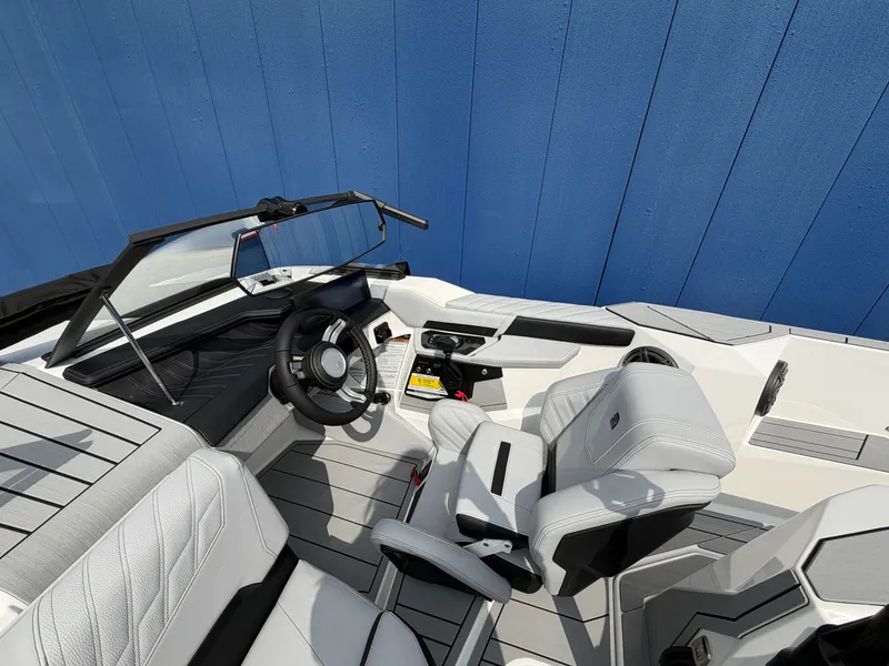 Slide: The Image of The image shows the cockpit of a modern Ski Nautique boat with white leather seats and a sleek dashboard. - 13
