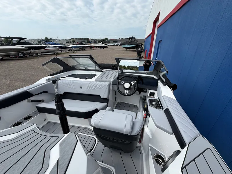 Slide: The Image of The image shows the cockpit of a 2027 Nautique Ski Nautique with modern seating and a sleek steering wheel. - 11