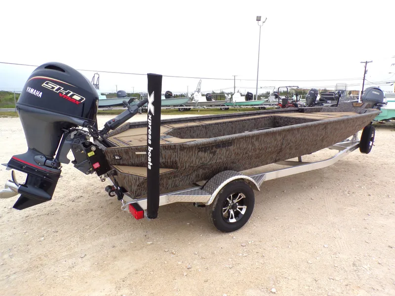 Slide: The Image of 2026 Xpress X18DB boat with Yamaha motor on trailer. - 14
