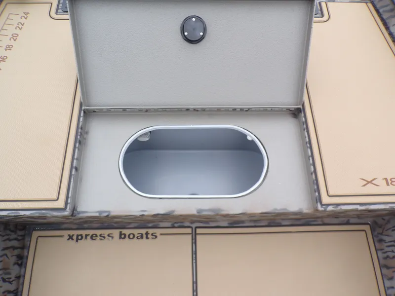 Slide: The Image of Xpress X18DB 2026 boat with open storage compartment. - 19