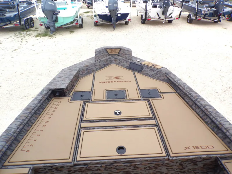 Slide: The Image of Xpress X18DB 2026 boat with storage compartments and ruler. - 6