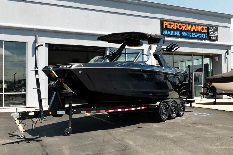 The Image of 2026 MasterCraft XStar 25 boat on trailer at Performance Marine Watersports dealership. - 0
