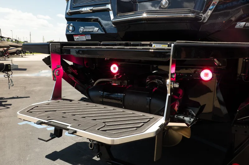 Slide: The Image of 2026 MasterCraft XStar 25 boat rear view with swim platform and illuminated lights. - 13