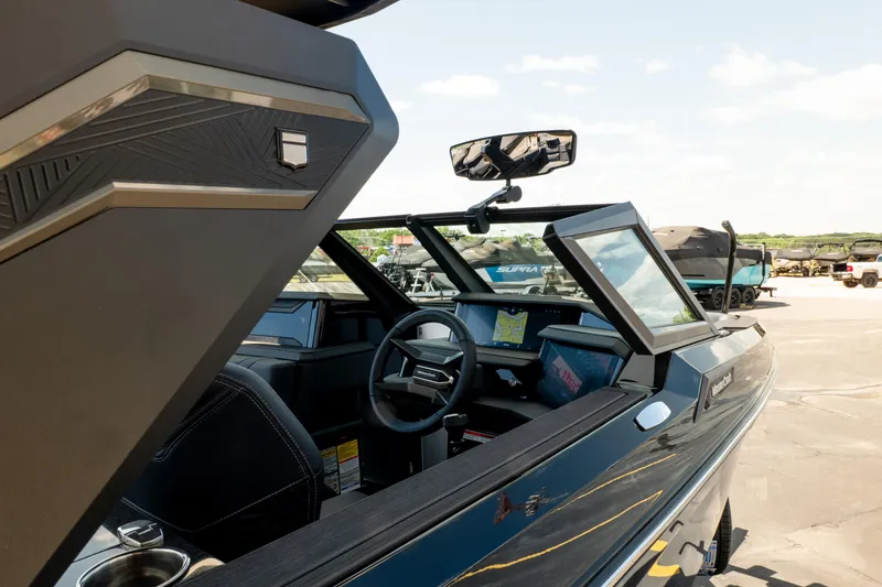 Slide: The Image of 2026 MasterCraft XStar 25 boat interior with modern dashboard and steering wheel. - 18